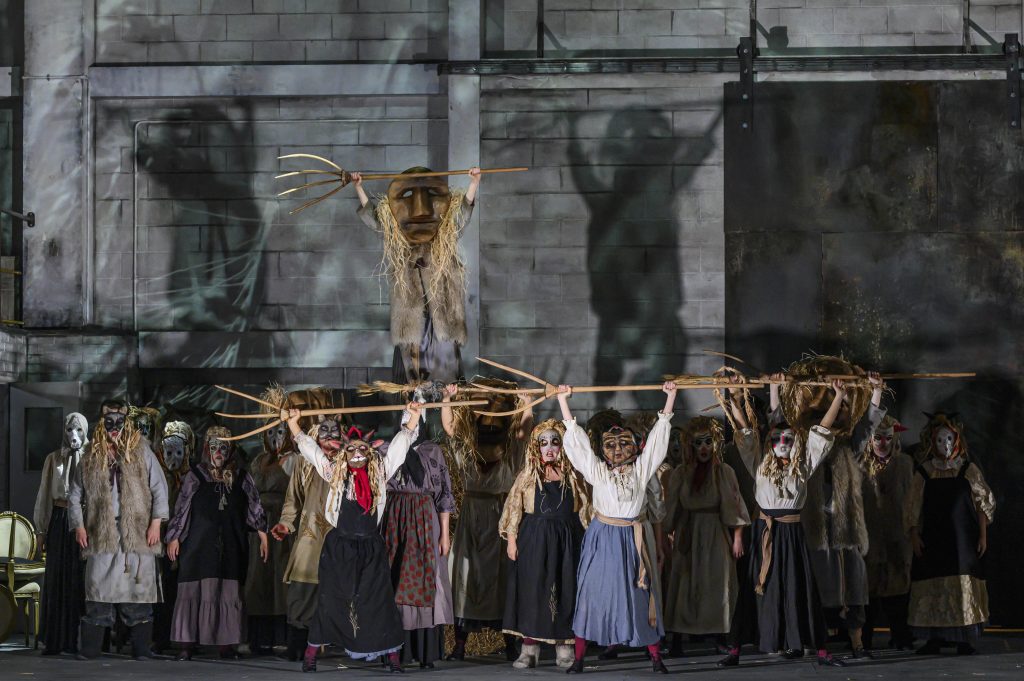 The image shows the NI Opera Chorus performing in Eugene Onegin in the Grand Opera House in 2024